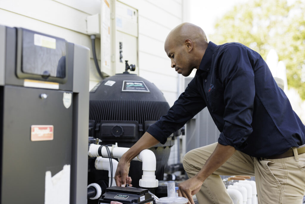 home inspector inspecting an outdoor air conditioning unit