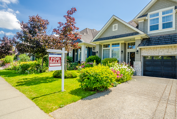 home with for sale sign in the front yard